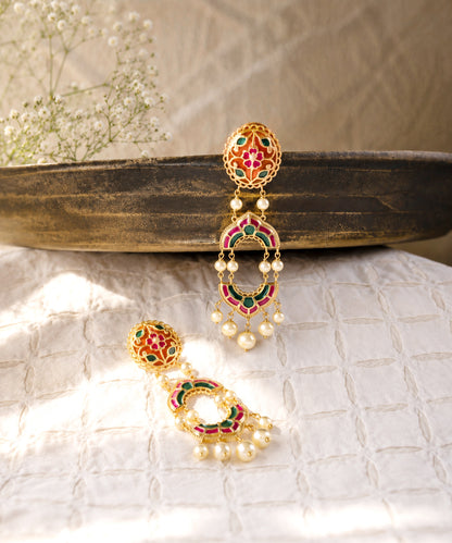 A pair of 925 silver traditional Indian dangle earrings with colorful enamel work in pink, green, and orange, adorned with small white pearl beads.