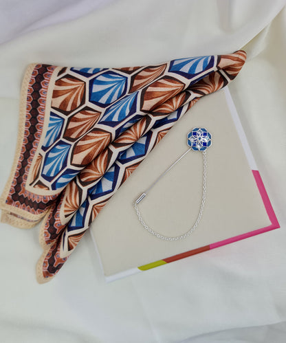 Handcrafted sterling silver lapel pin paired with a hand-painted silk pocket square.