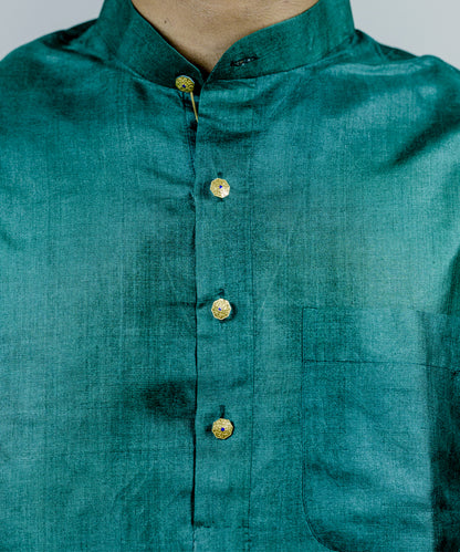 Gold kurta buttons with blue detailing.