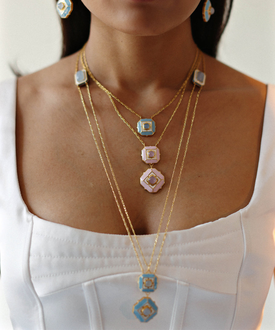 Model wearing ripple blue octa chain necklace and cloudy pink and ripple blue deep dive long chain necklace from tranquil collection by manner india.