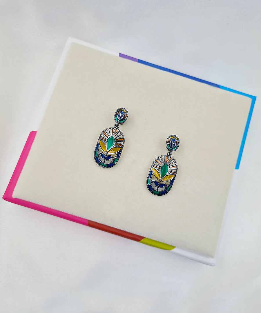 Festive handcrafted 925 sterling silver floral earrings featuring green and yellow meenakari enamel with black rhodium finish.